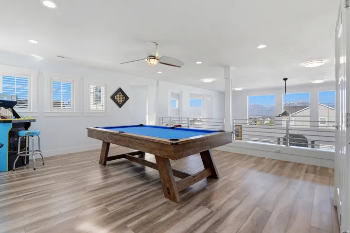 Spacious bonus room featuring wood-finish flooring, recessed lighting, and a ceiling fan