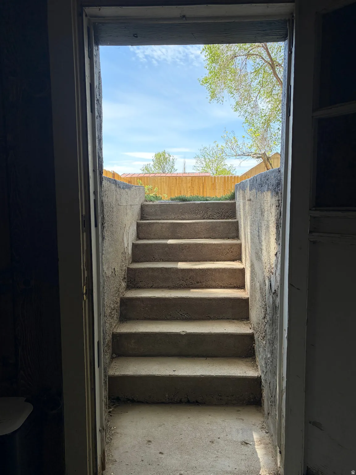 Exterior concrete staircase providing access to the property
