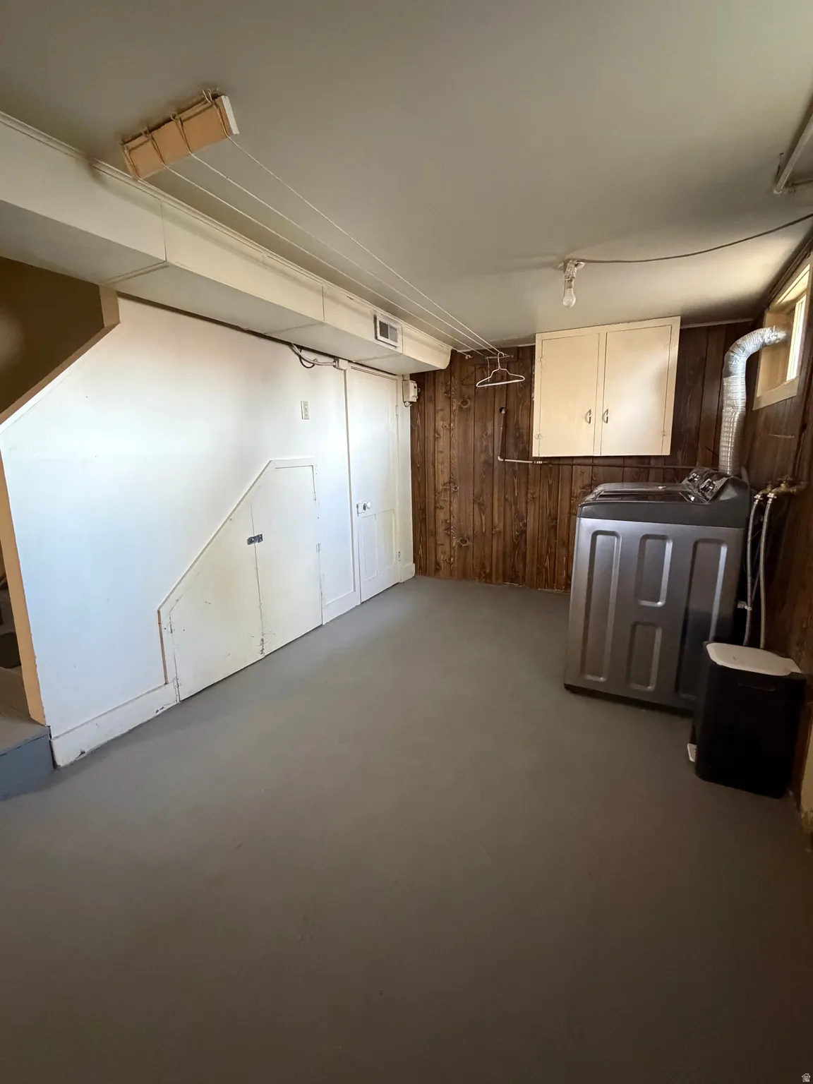 Utility space featuring a painted concrete floor