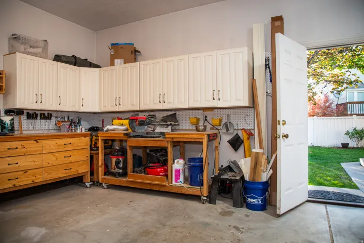 Built in garage cupboards and door to backyard.  Garage is extra wide and deep! There are built in deep garage shelves on right side of door.