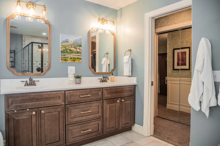 Dual sink vanity with a quartz countertop and wood-finish cabinetry