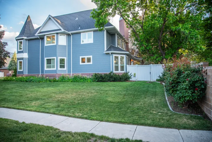 North side of home.  Two-story residential exterior featuring a turret, and bay windows.
