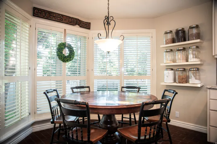 Bay window dining area / breakfast nook with plantation shutters