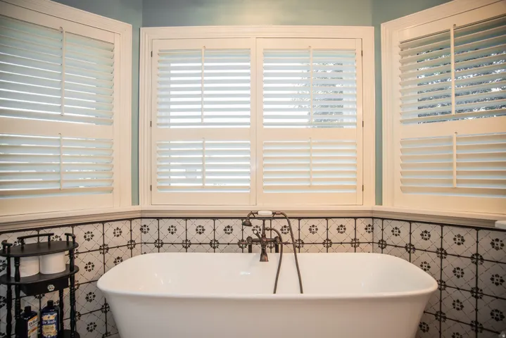 Float away from your troubles in this gorgeous freestanding soaking tub with floor-mounted faucet, complemented by patterned tile wainscoting.