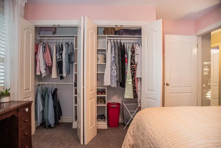Each closet has multi-level hanging rods and built-in shelves