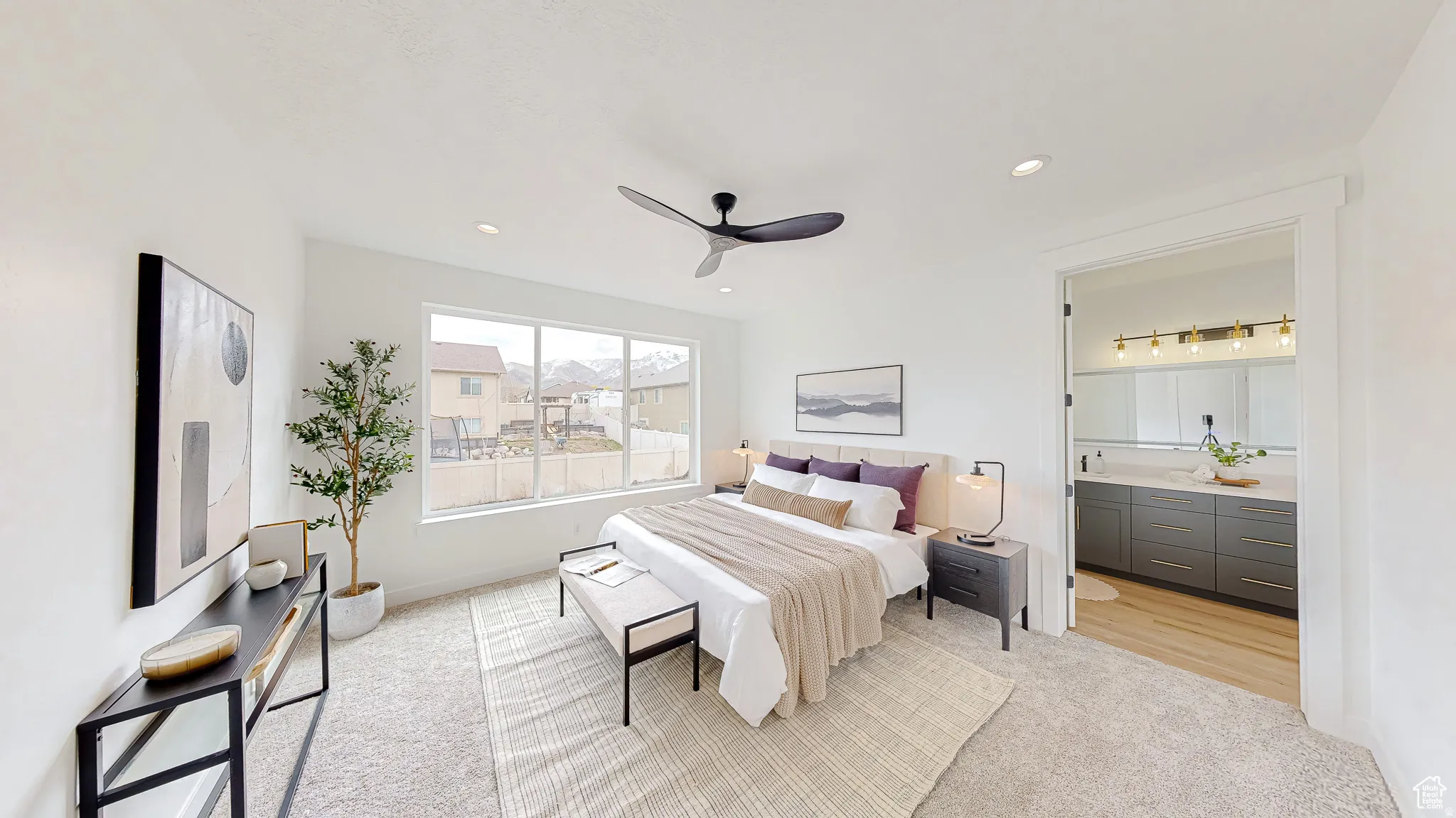 Spacious bedroom with light-toned carpeting and a large window