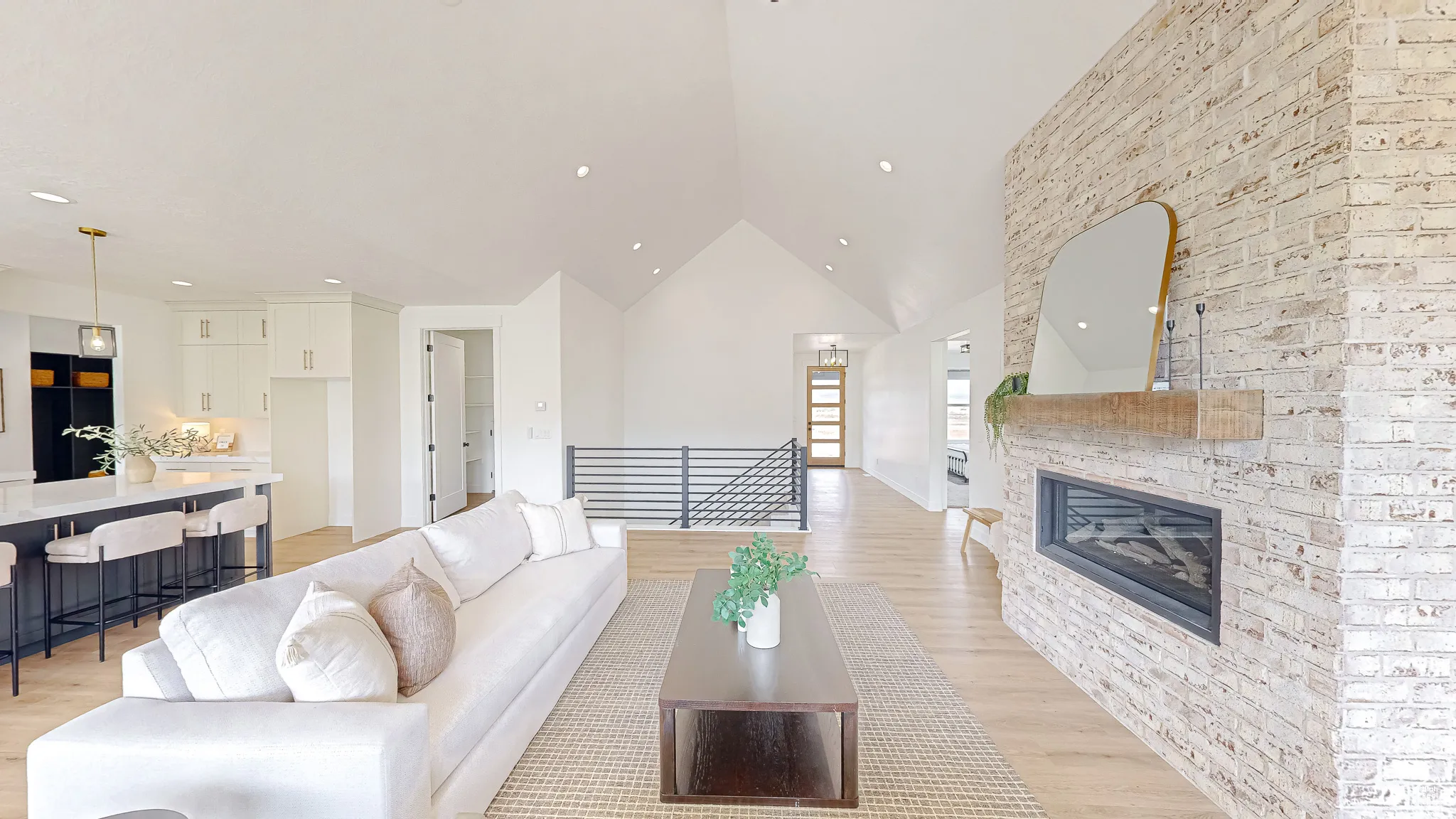 Great room with vaulted ceilings and wood-finish flooring
