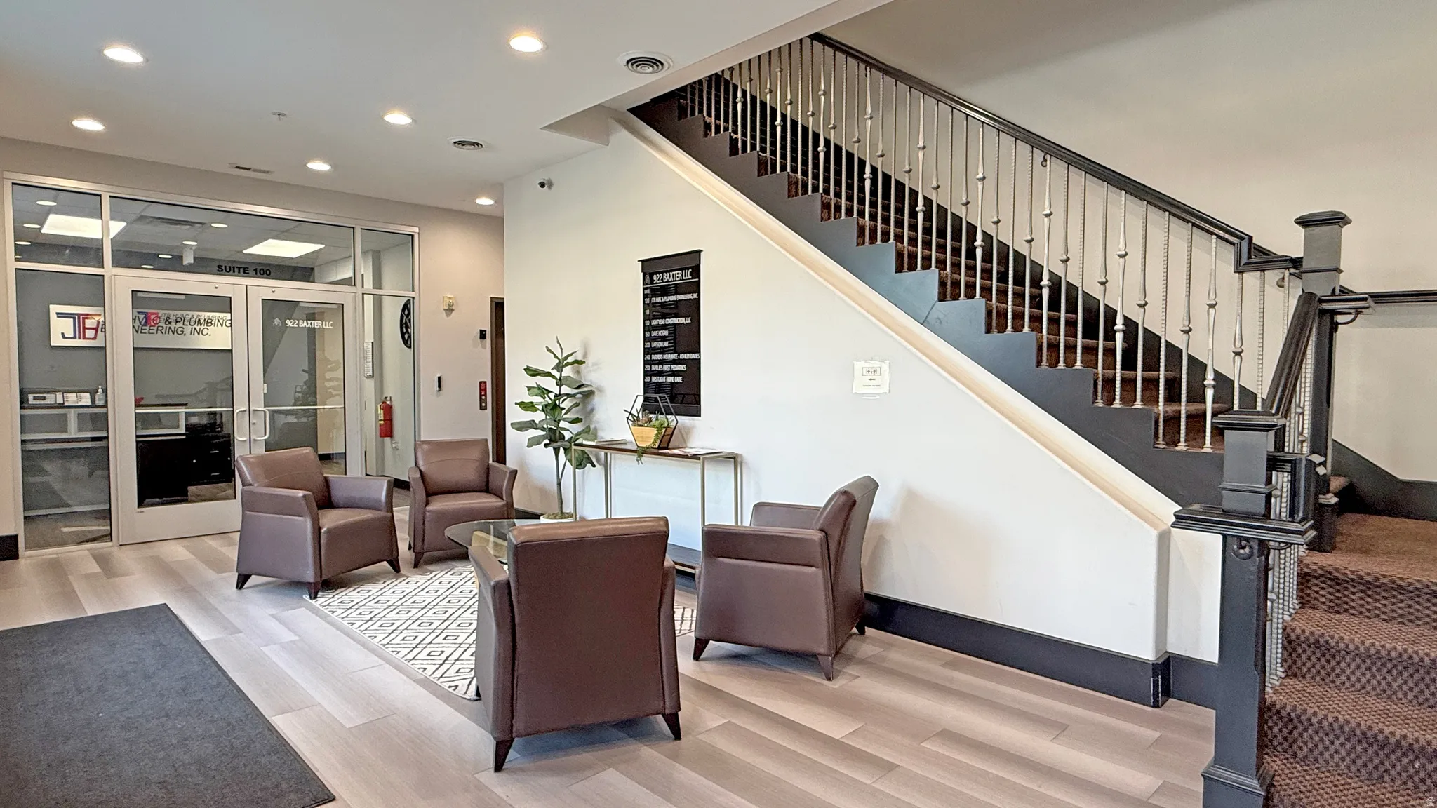 Professional lobby entry with wood-finish flooring and recessed lighting