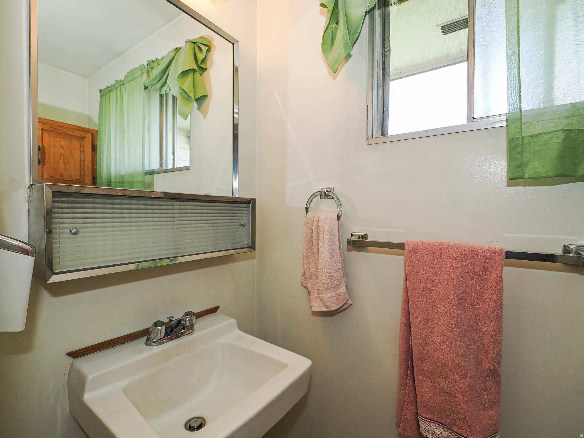 Wall-mounted porcelain sink with chrome faucet