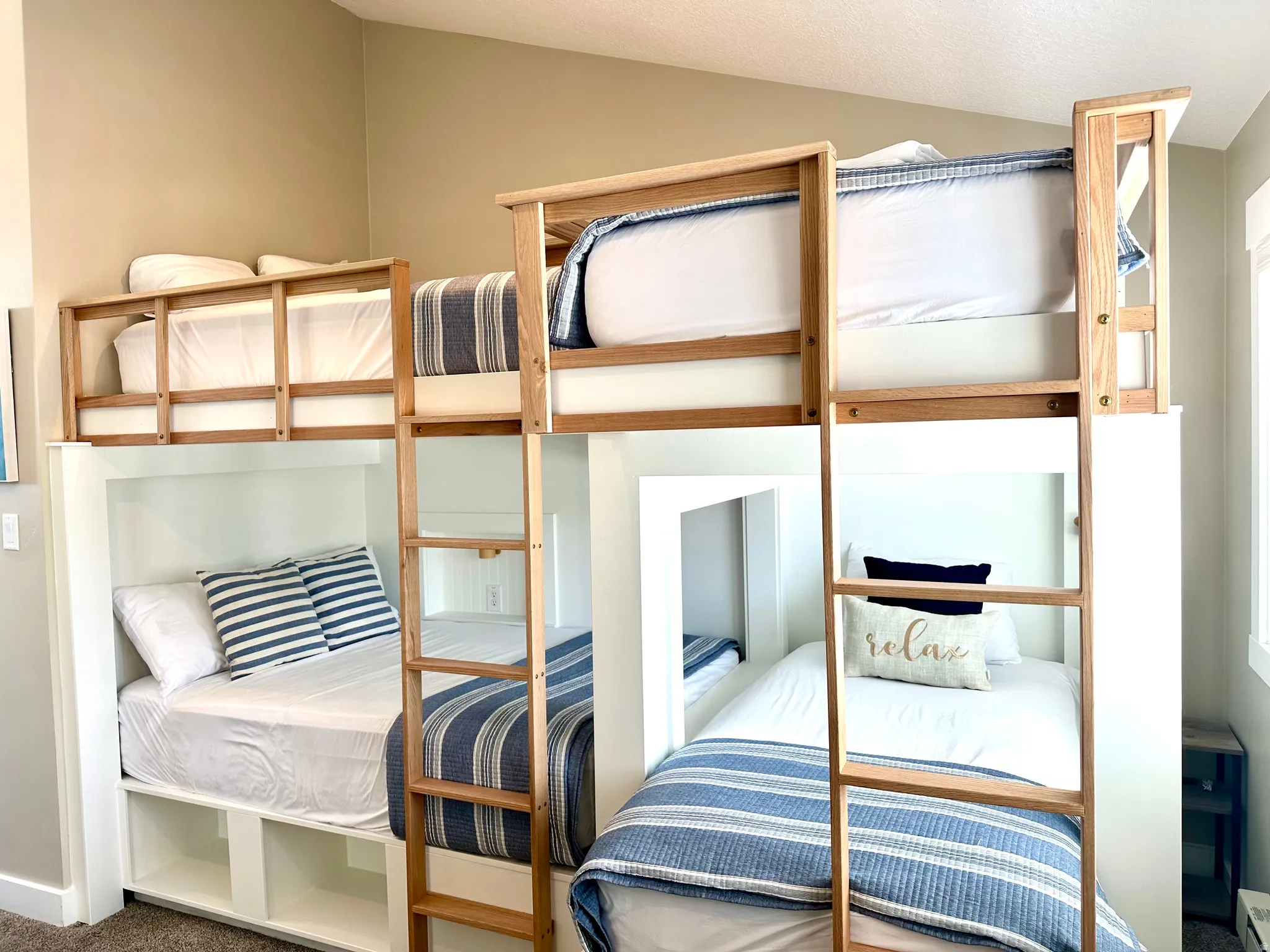 Built-in bunk bed system featuring natural wood-finish ladders and safety rails