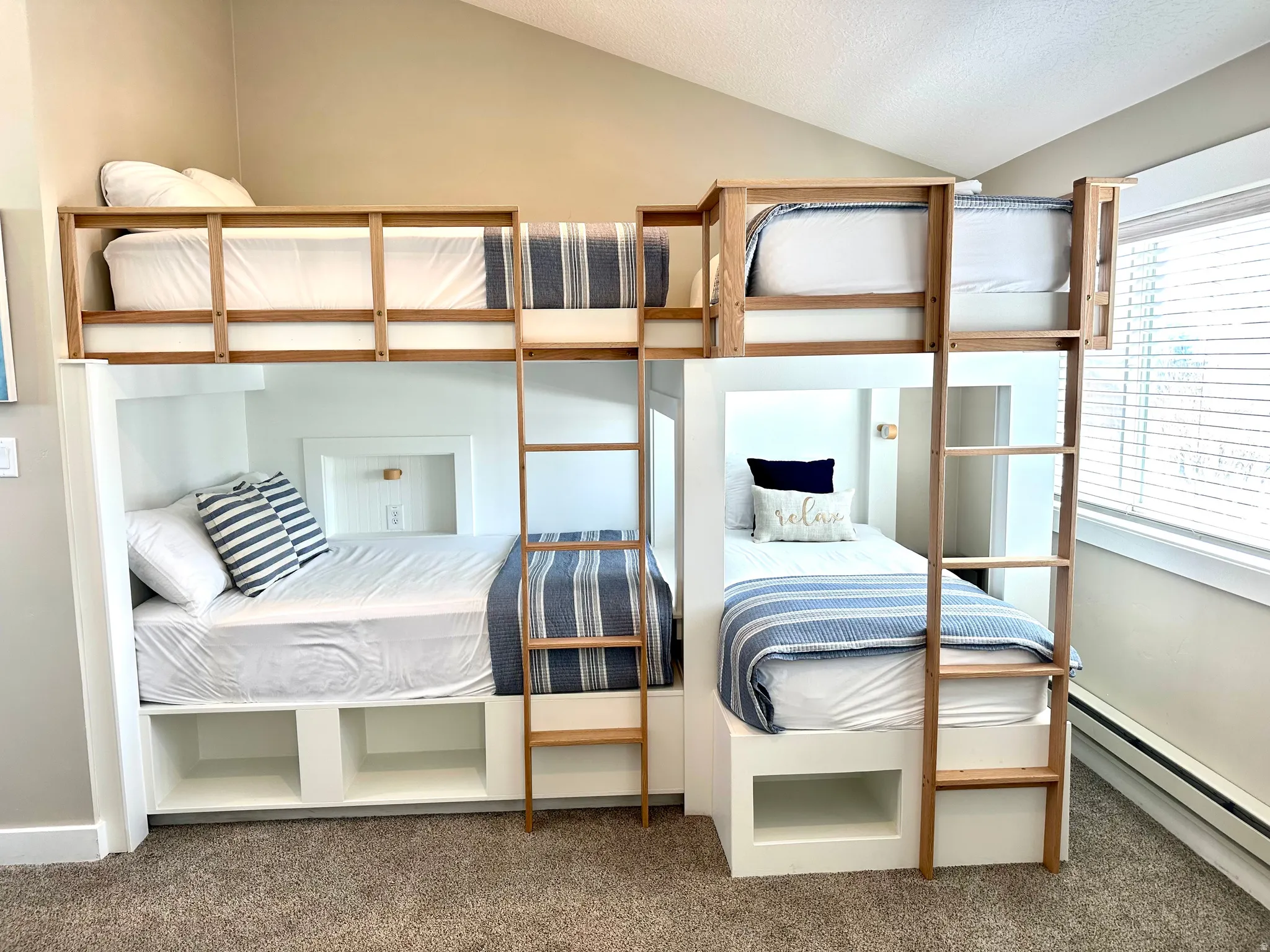 Custom-built bunk beds with integrated storage and natural wood ladders
