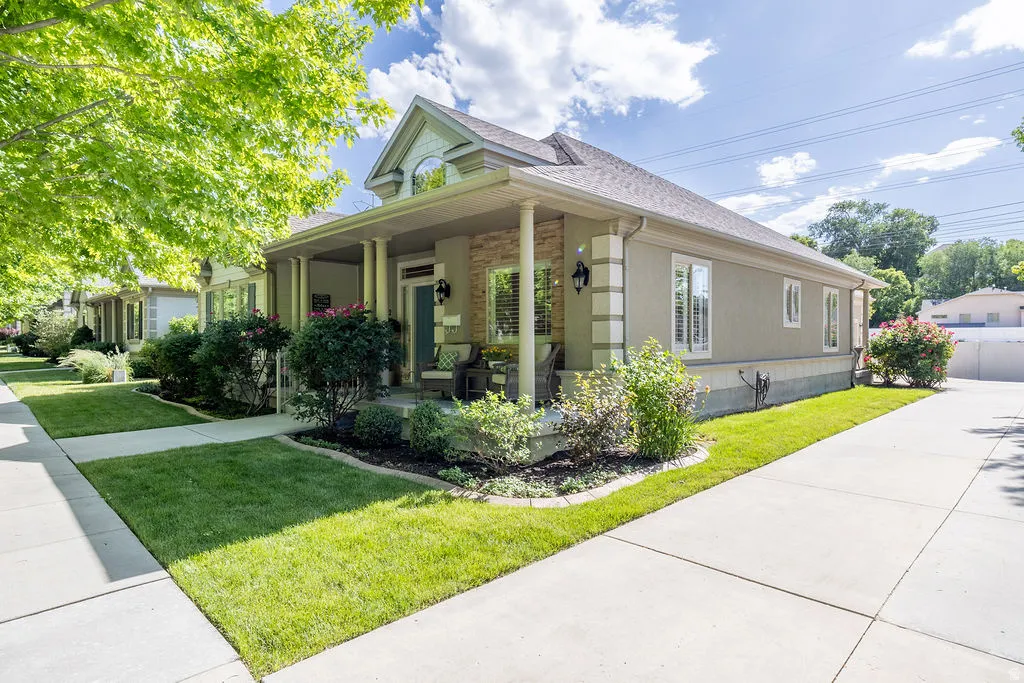 Single-story residence featuring a covered front porch with columns, a prominent front gable, and a stone-accented facade