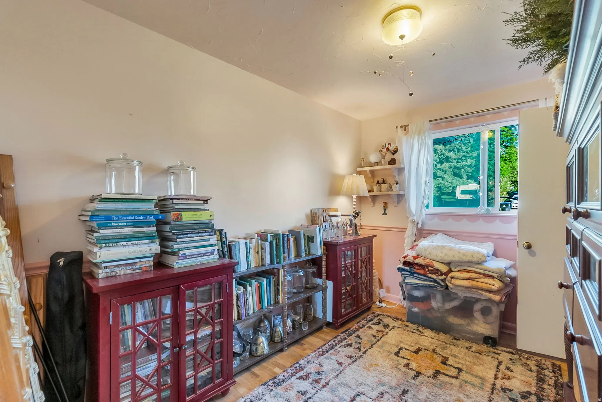 Hardwood-style flooring and a flush-mount ceiling light fixture enhance this room