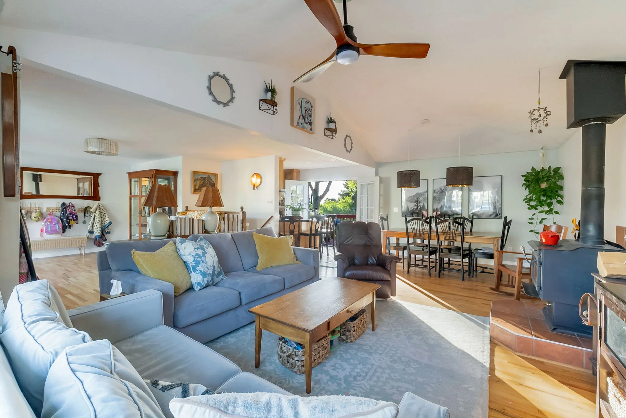 Vaulted ceilings in this spacious living area with wood-finish flooring