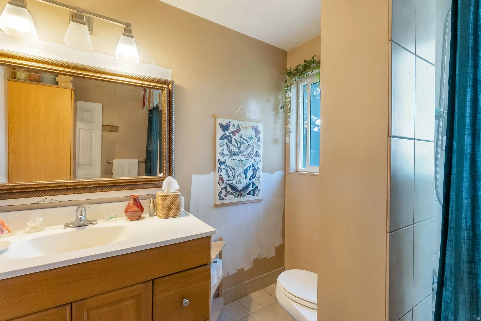 Bathroom featuring a vanity with a light wood-finish cabinet and a white countertop