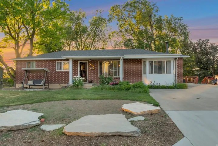 Brick exterior residence with a shingled roof