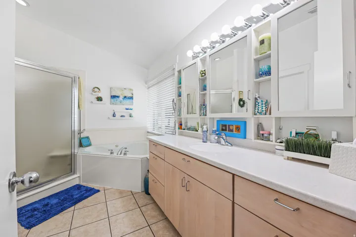 Dual vanity with integrated sinks and wood-finish cabinetry