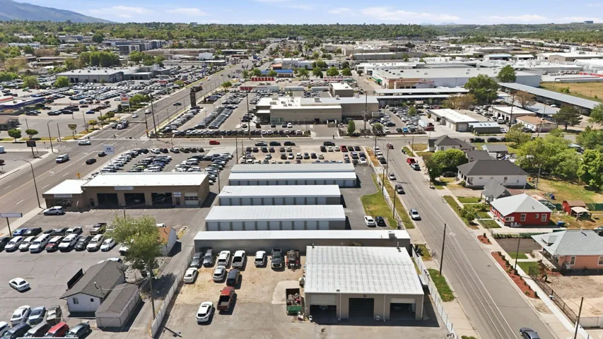 Industrial property featuring multiple buildings, extensive asphalt paving, and a clear span structure