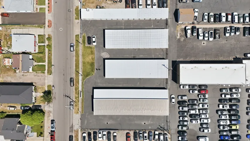 Aerial perspective showcasing multiple commercial structures and expansive paved parking areas