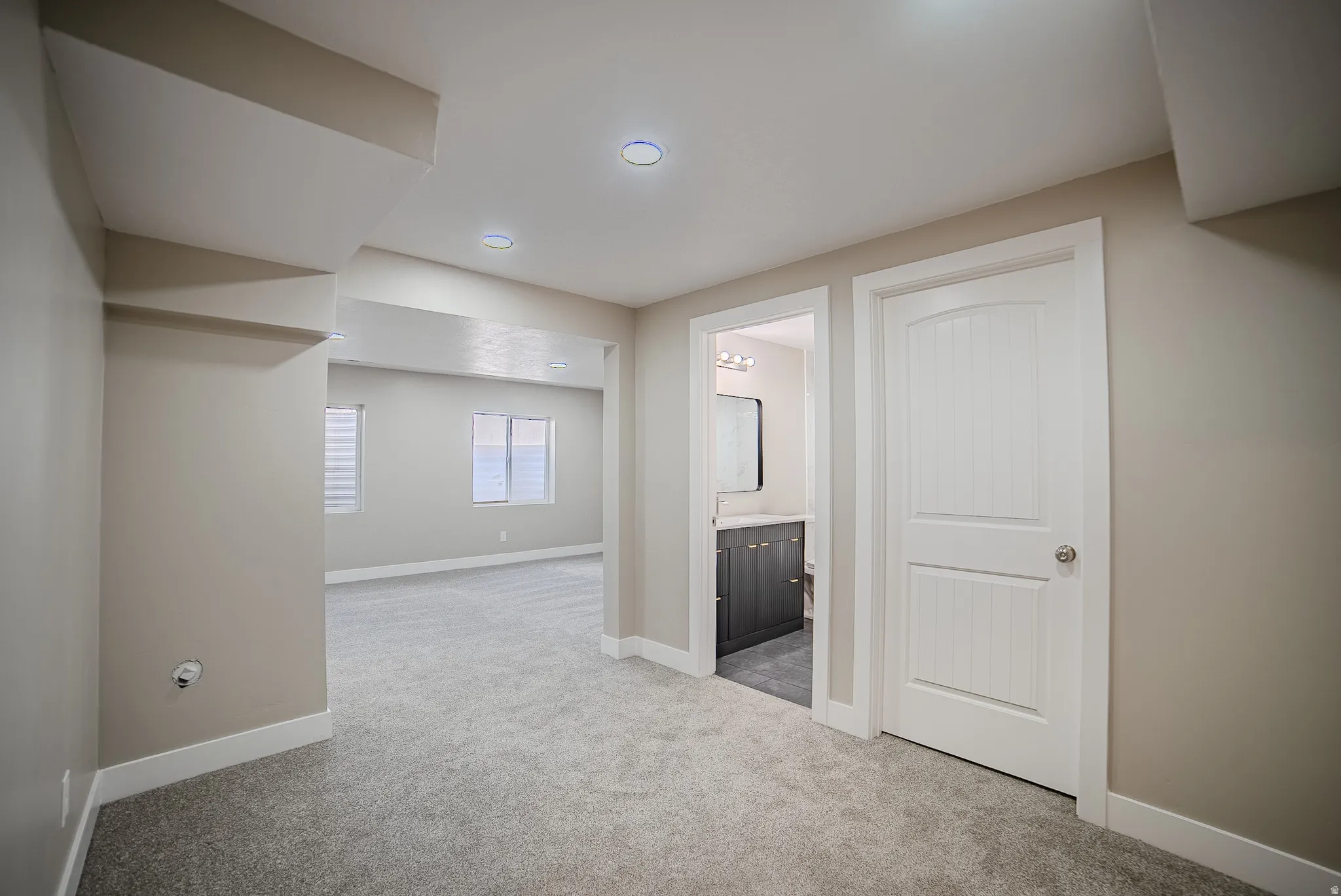 Spacious interior featuring neutral carpeting and recessed lighting