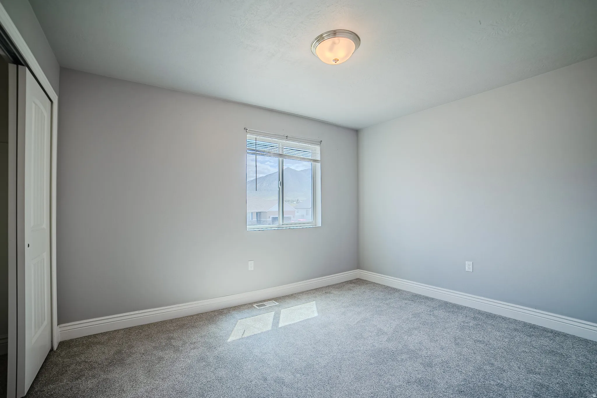Neutral tone walls with soft gray carpeting