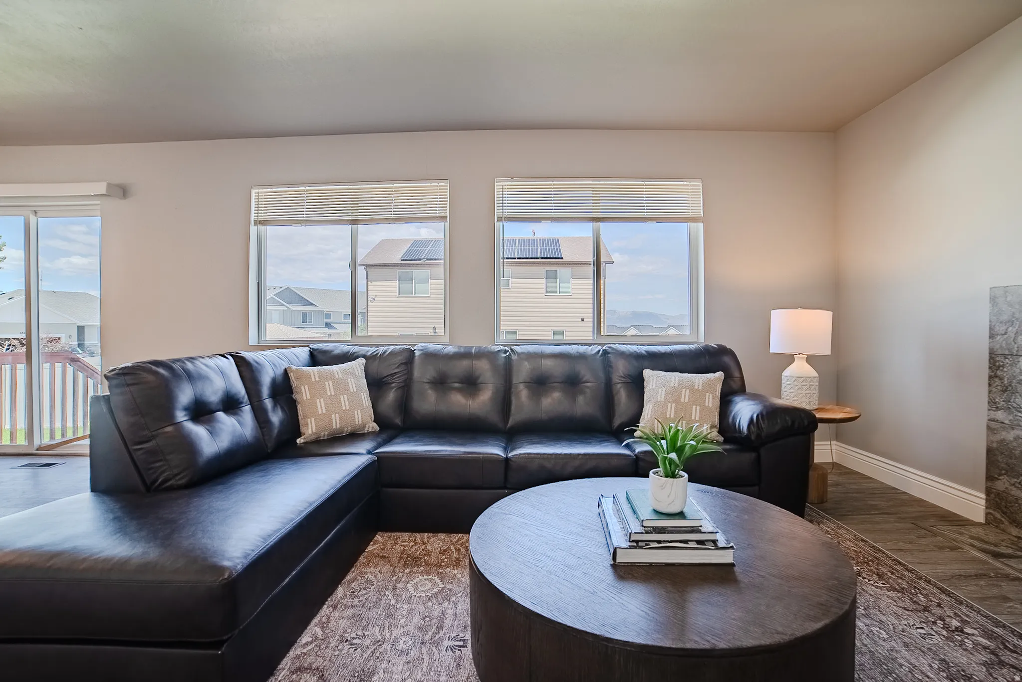 Living area with light neutral walls and wood-finish flooring