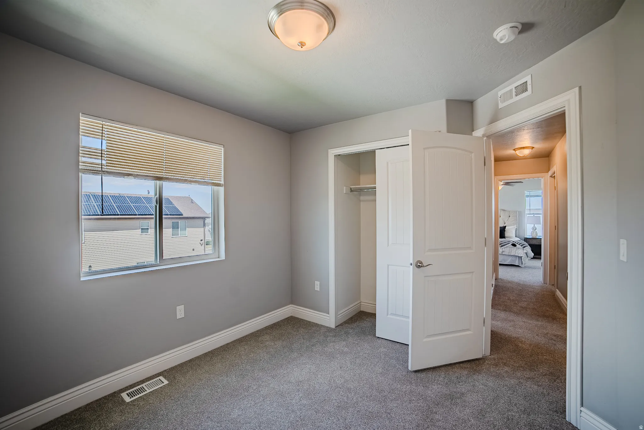 Neutral gray walls with white trim and gray carpeting