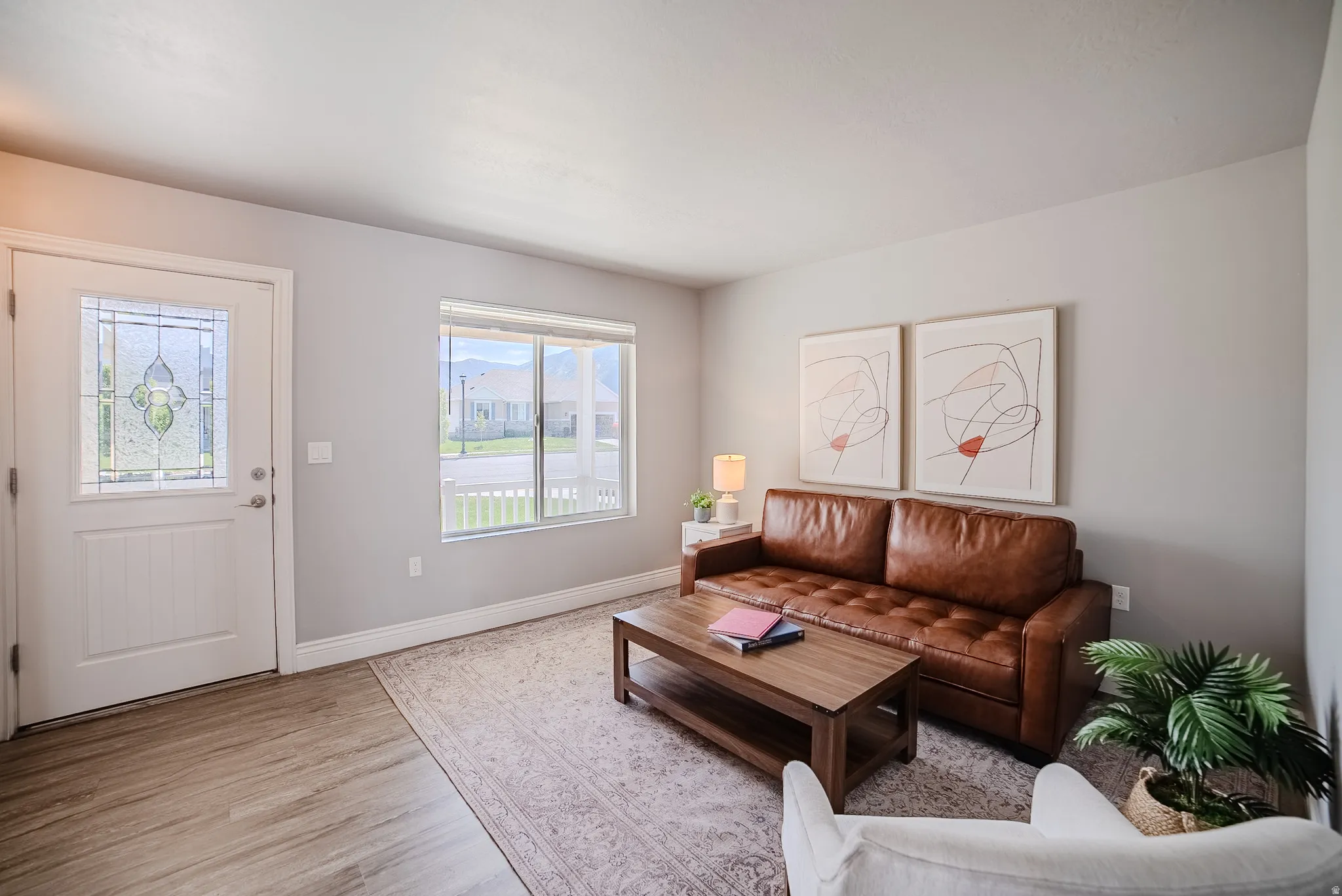 Entryway featuring a decorative glass panel door and wood-finish flooring