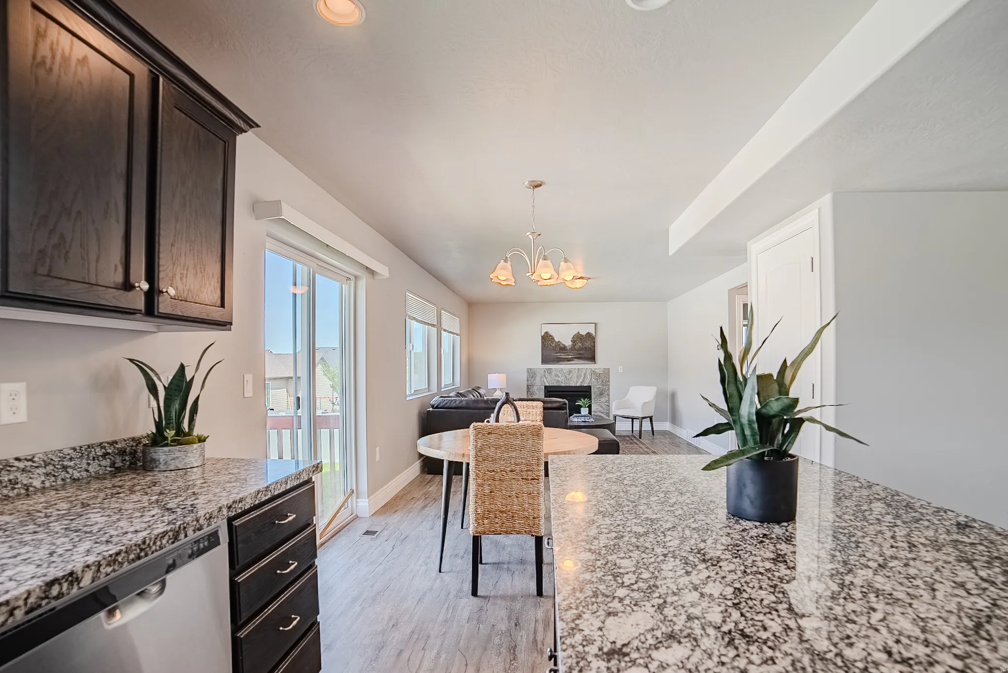 Open concept living area featuring wood-finish flooring, recessed lighting, and sliding glass door access to an outdoor area