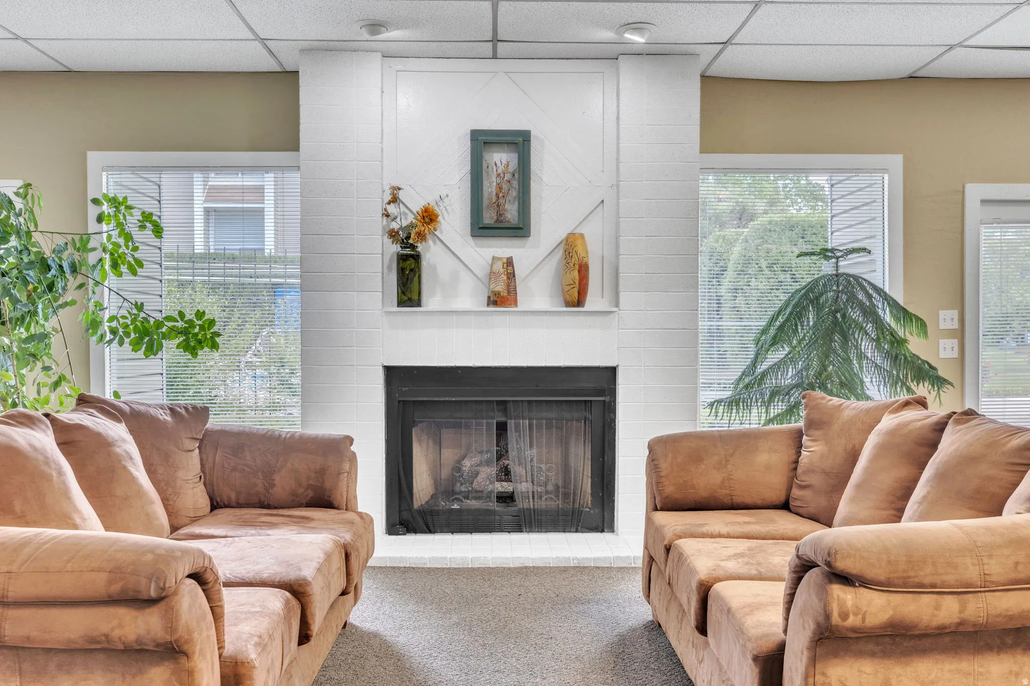 White brick-style fireplace featuring a black firebox and a mantle shelf