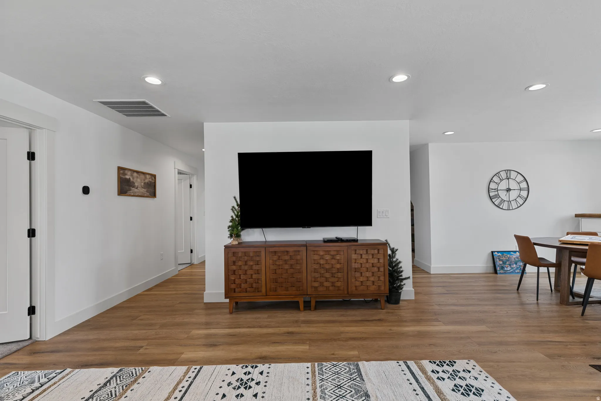 Open-concept living area with wood-finish flooring