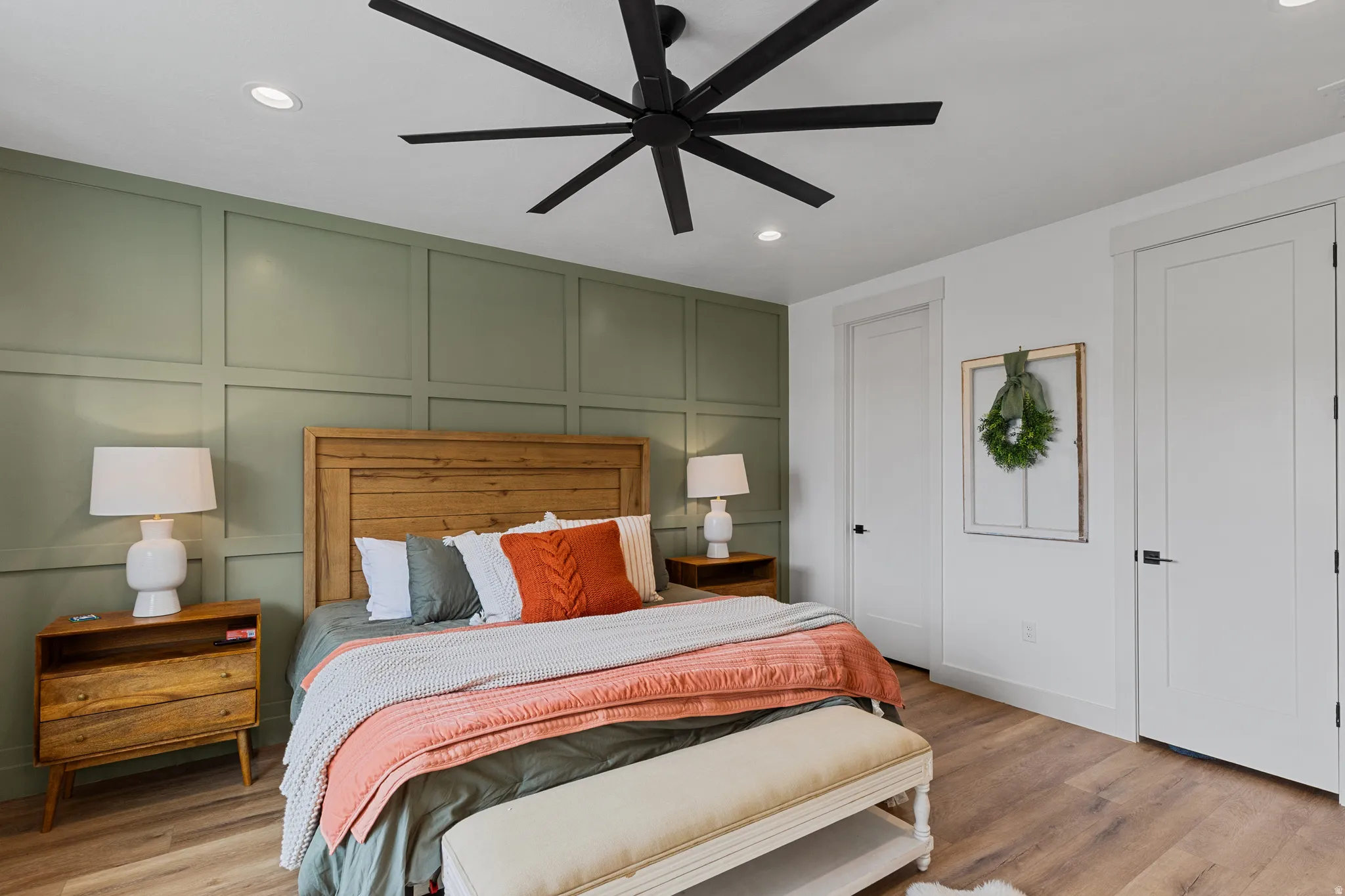 Feature wall with paneling detail and a wood-finish headboard