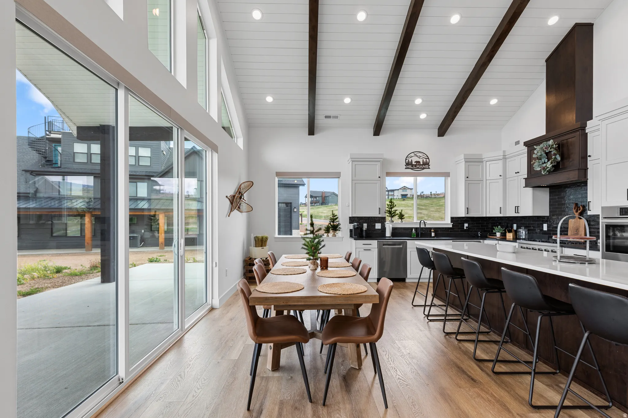 Spacious dining area with wood-finish flooring and extensive sliding glass doors