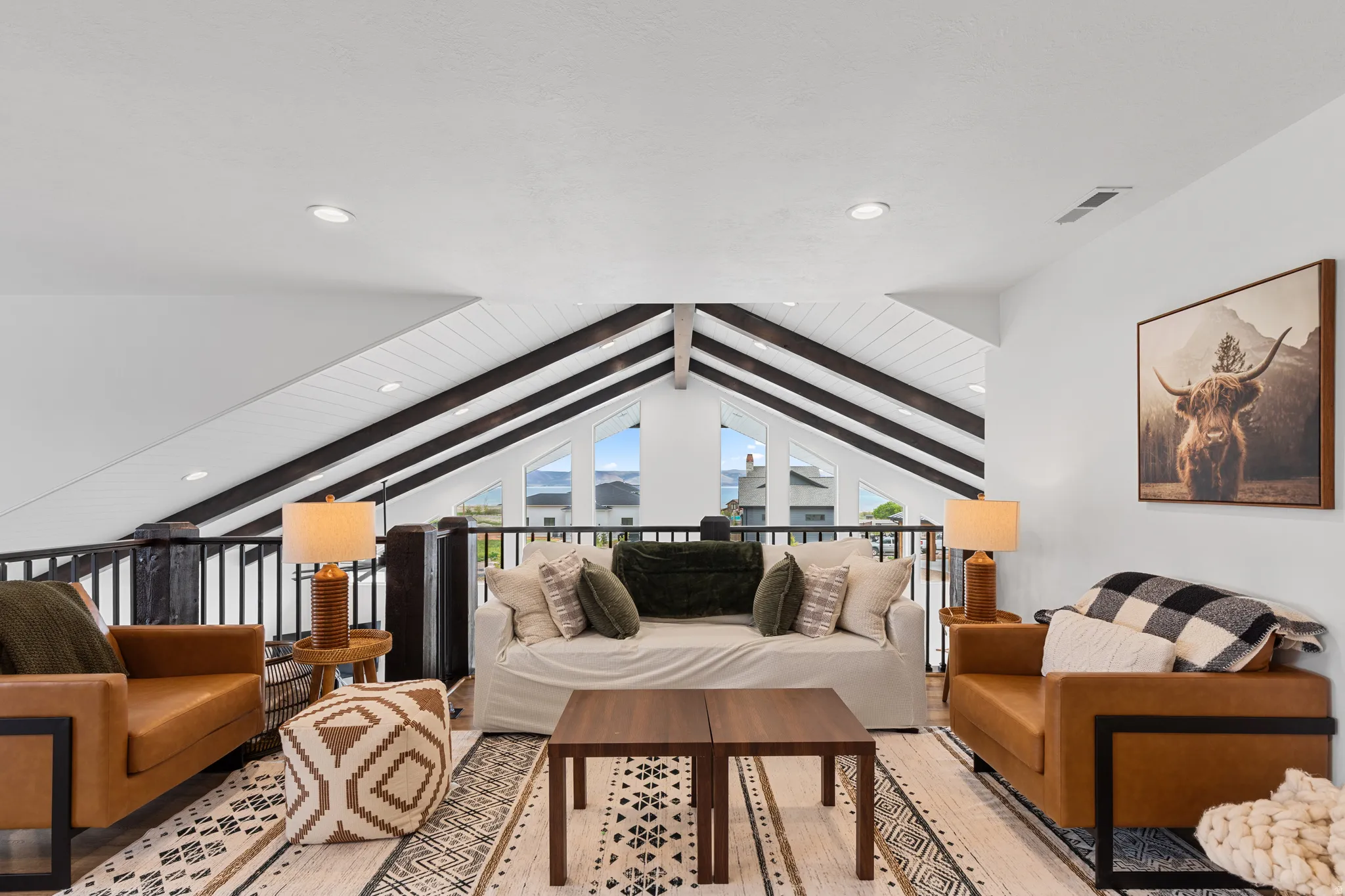 Vaulted ceiling with exposed dark beams and white planking