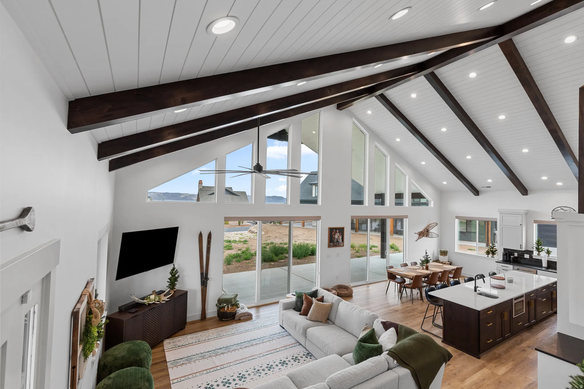 Vaulted ceiling with exposed wood beams and recessed lighting