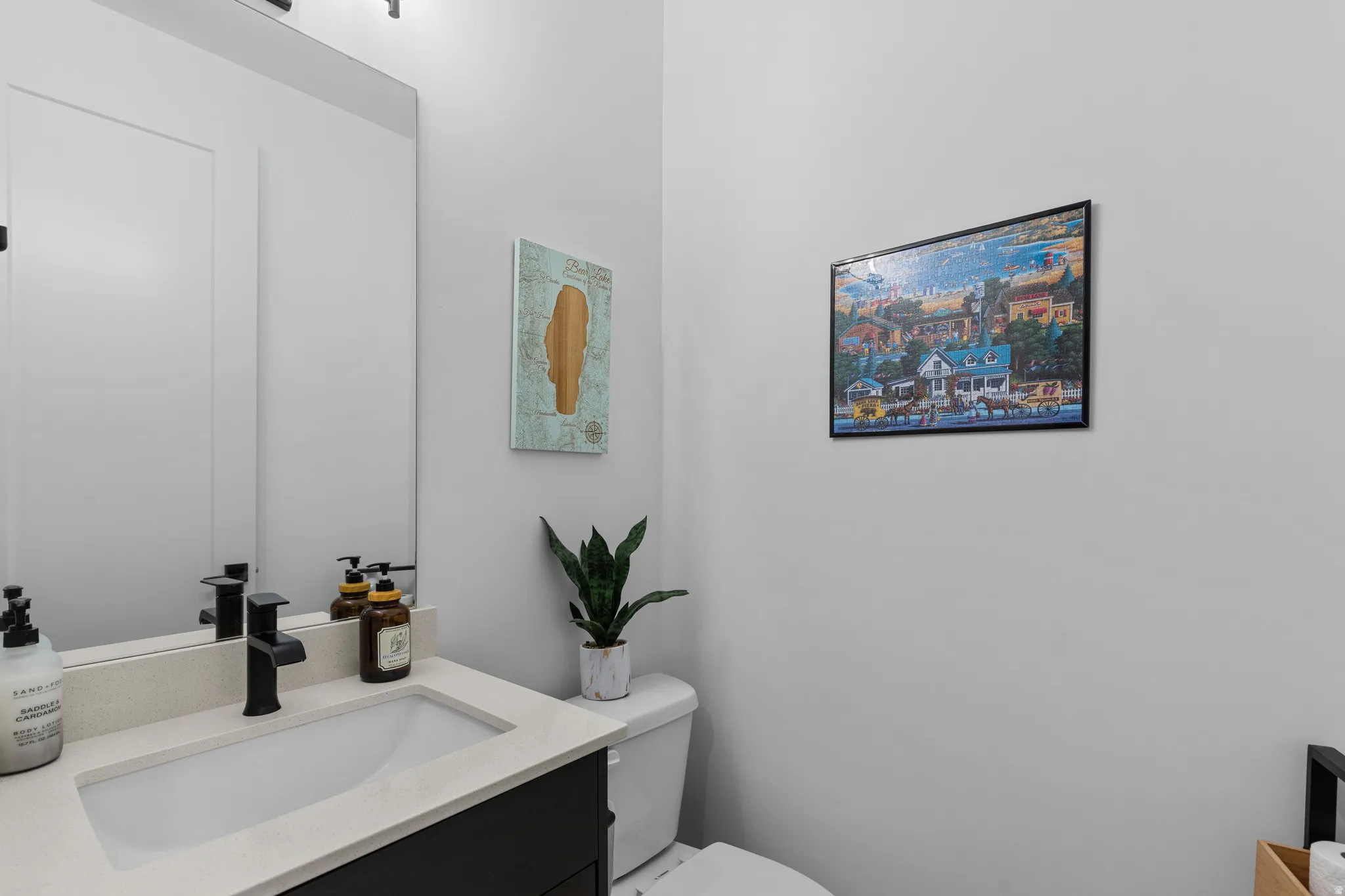 Contemporary vanity with a rectangular undermount sink, light-toned countertop, and matte black faucet