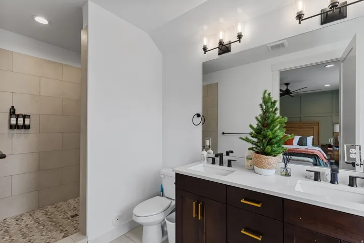 Dual vanity with dark wood cabinetry and gold-tone hardware