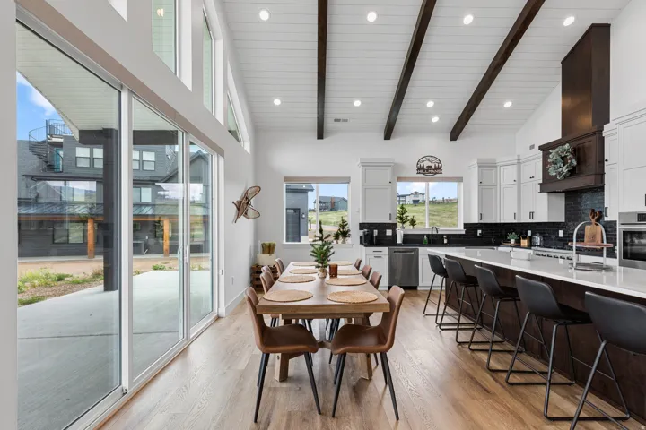 Spacious dining area with wood-finish flooring and extensive sliding glass doors