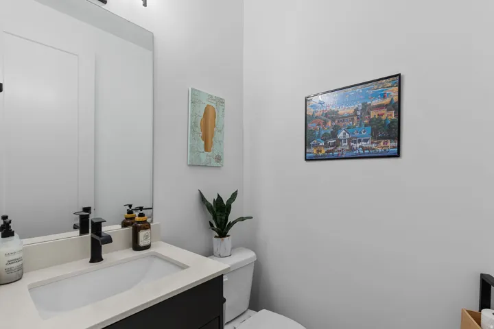Contemporary vanity with a rectangular undermount sink, light-toned countertop, and matte black faucet