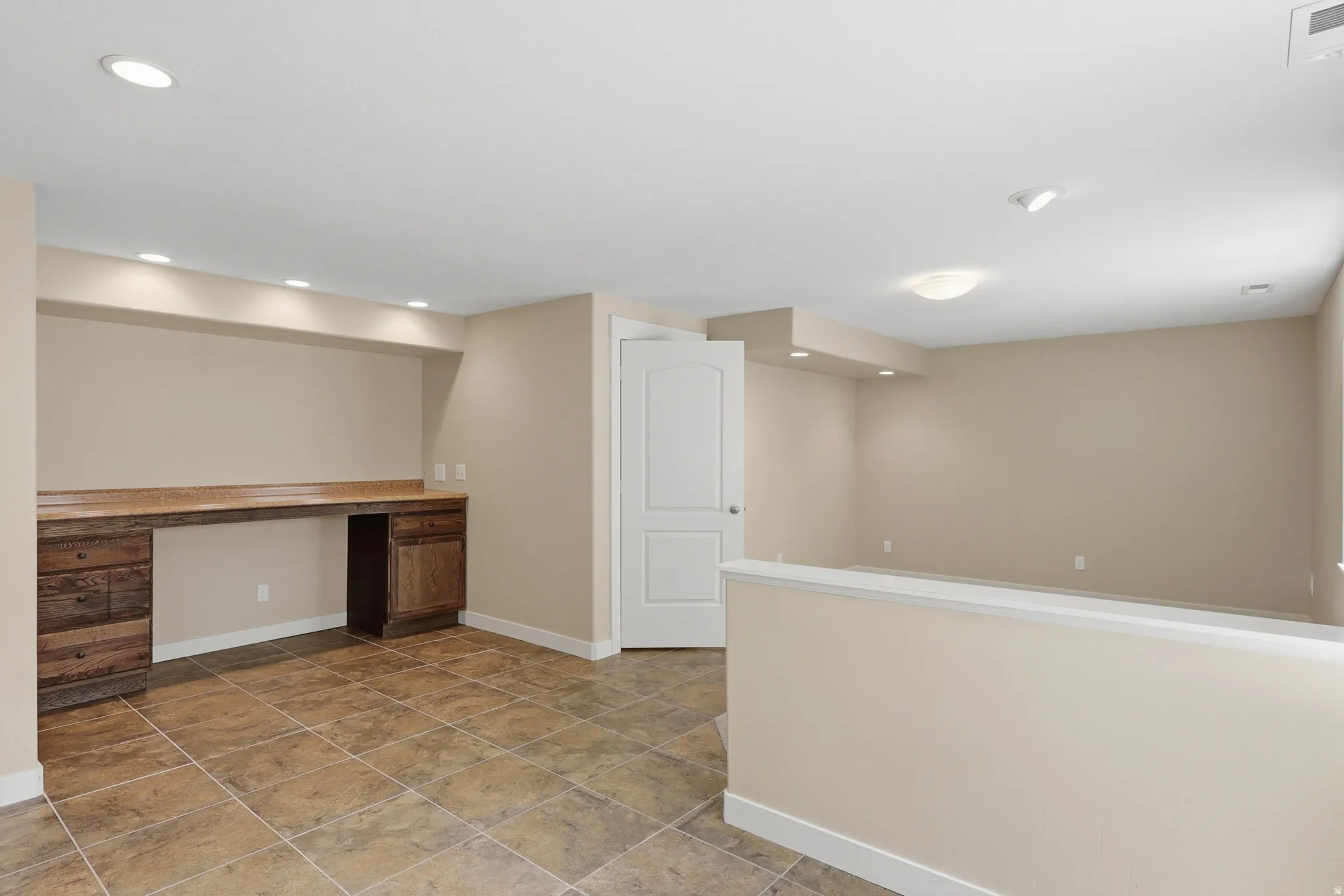 A large room used as a recreation room with a bar.  It could be two bedrooms if desired.