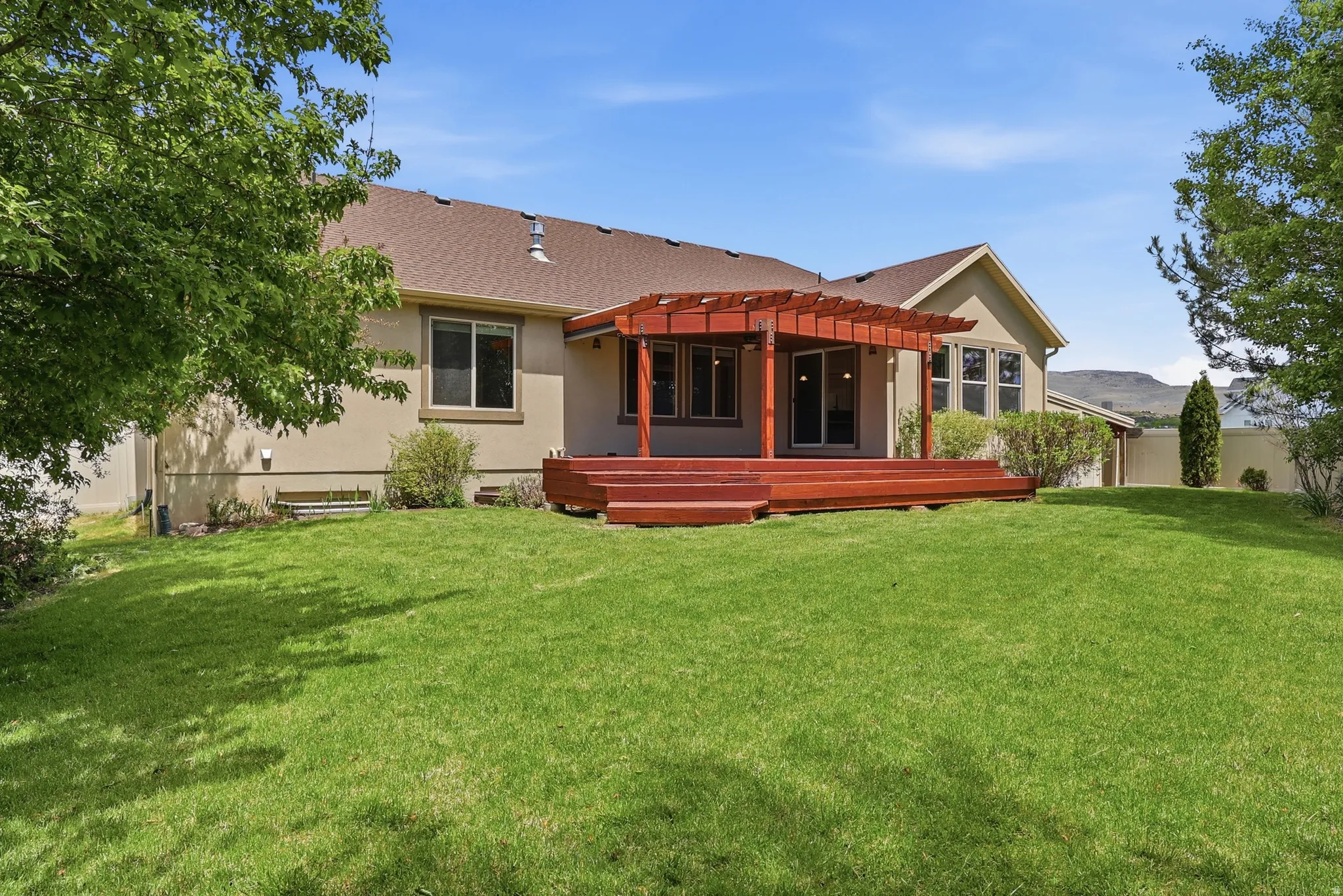 Beautifully landscaped private, fenced back yard with no back neighbors and a covered deck for BBQs, and relaxing.