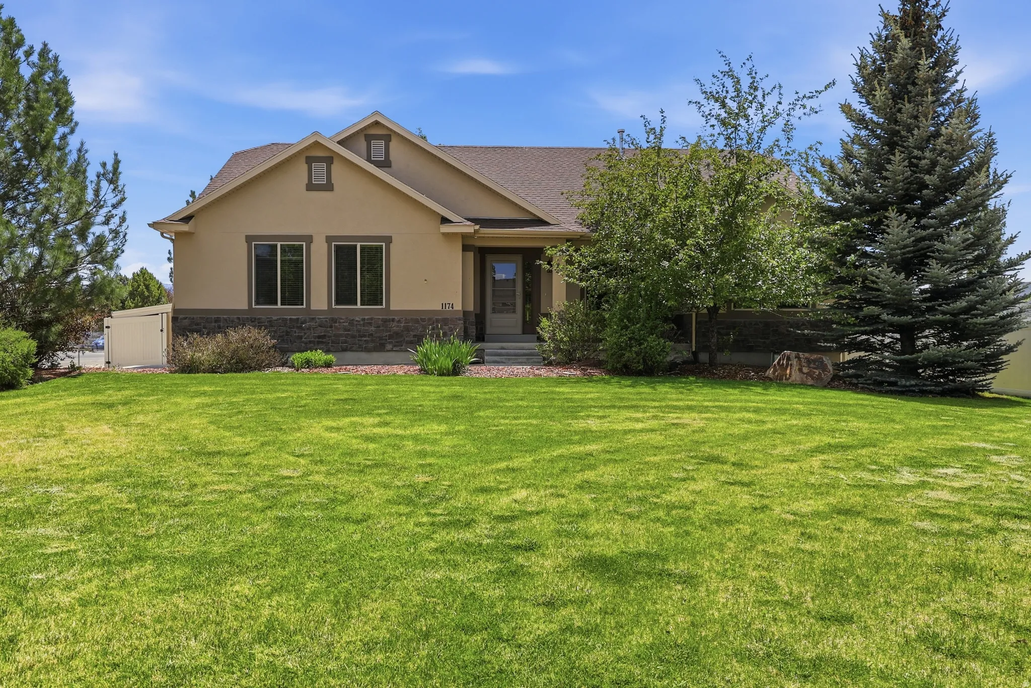 Expansive front lawn with mature landscaping