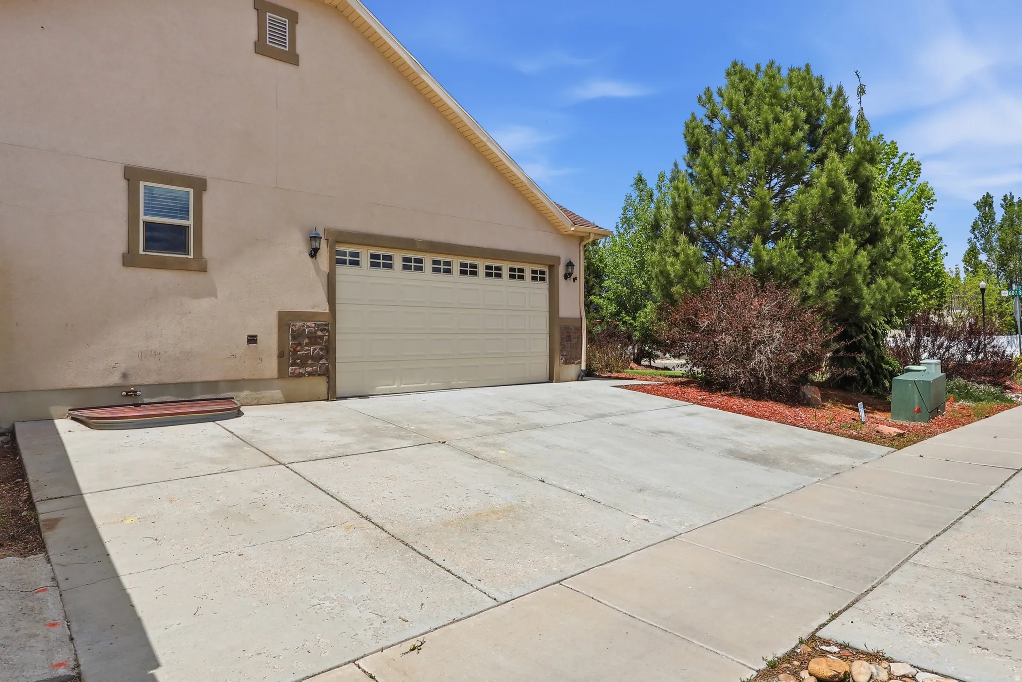 Concrete driveway with a two-car garage and auxiliary or RV parking.