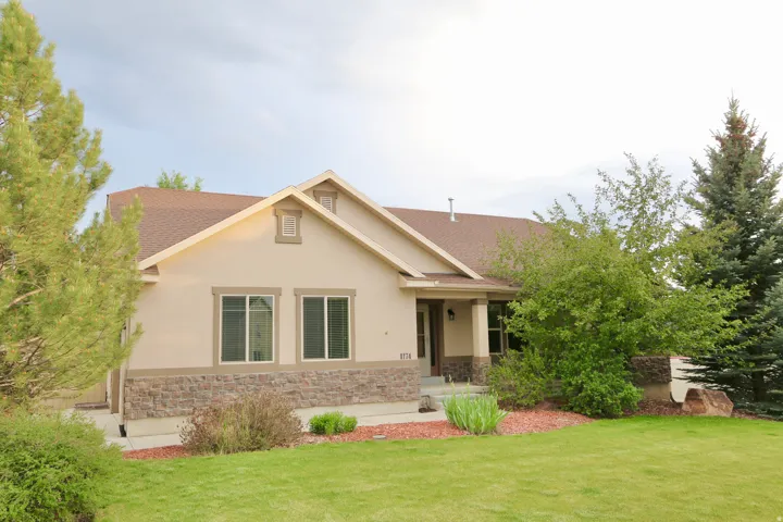 Ranch-style residence on a large corner lot with a covered porch.