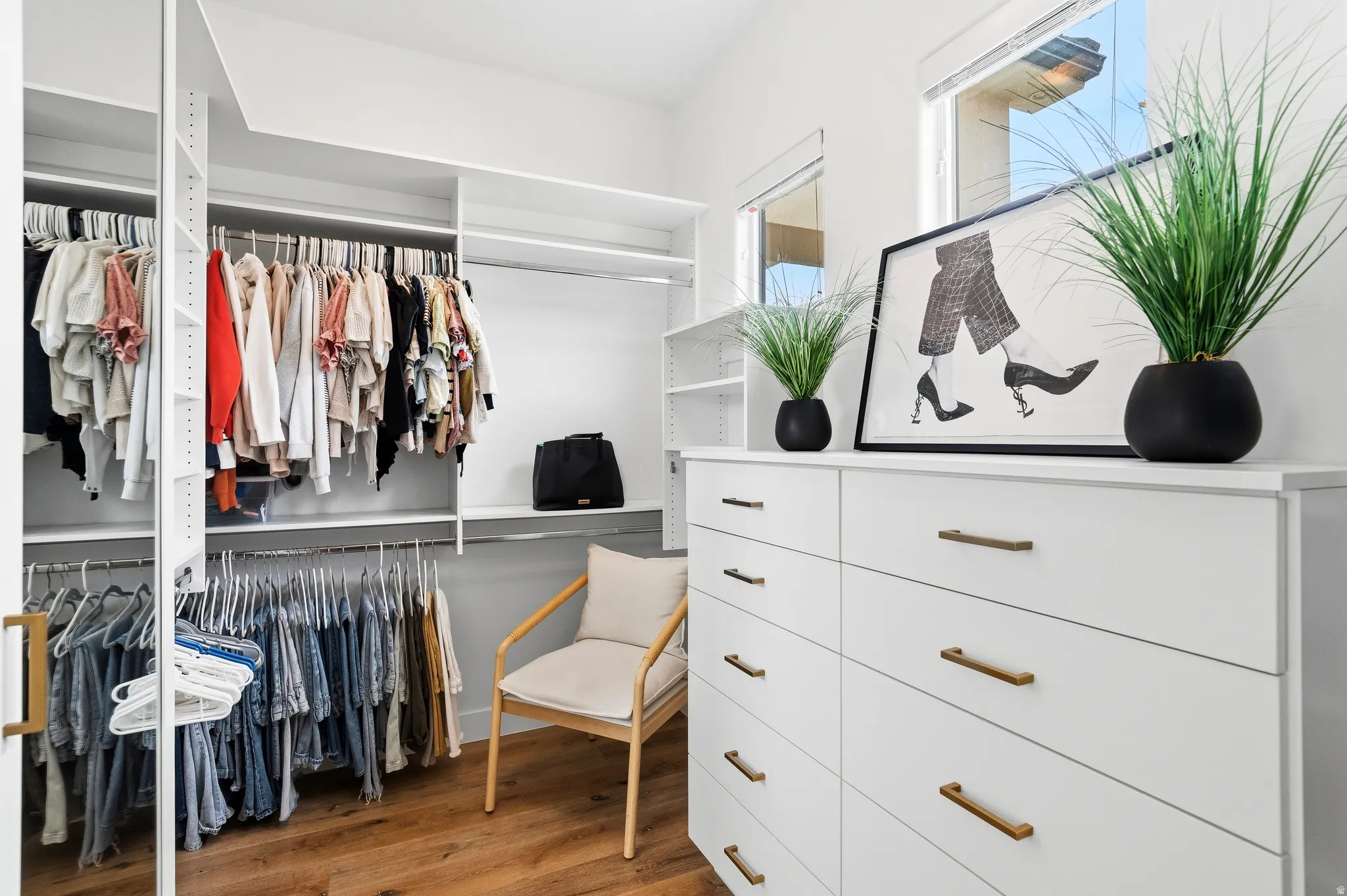 Custom closet system featuring multiple hanging rods and integrated shelving.