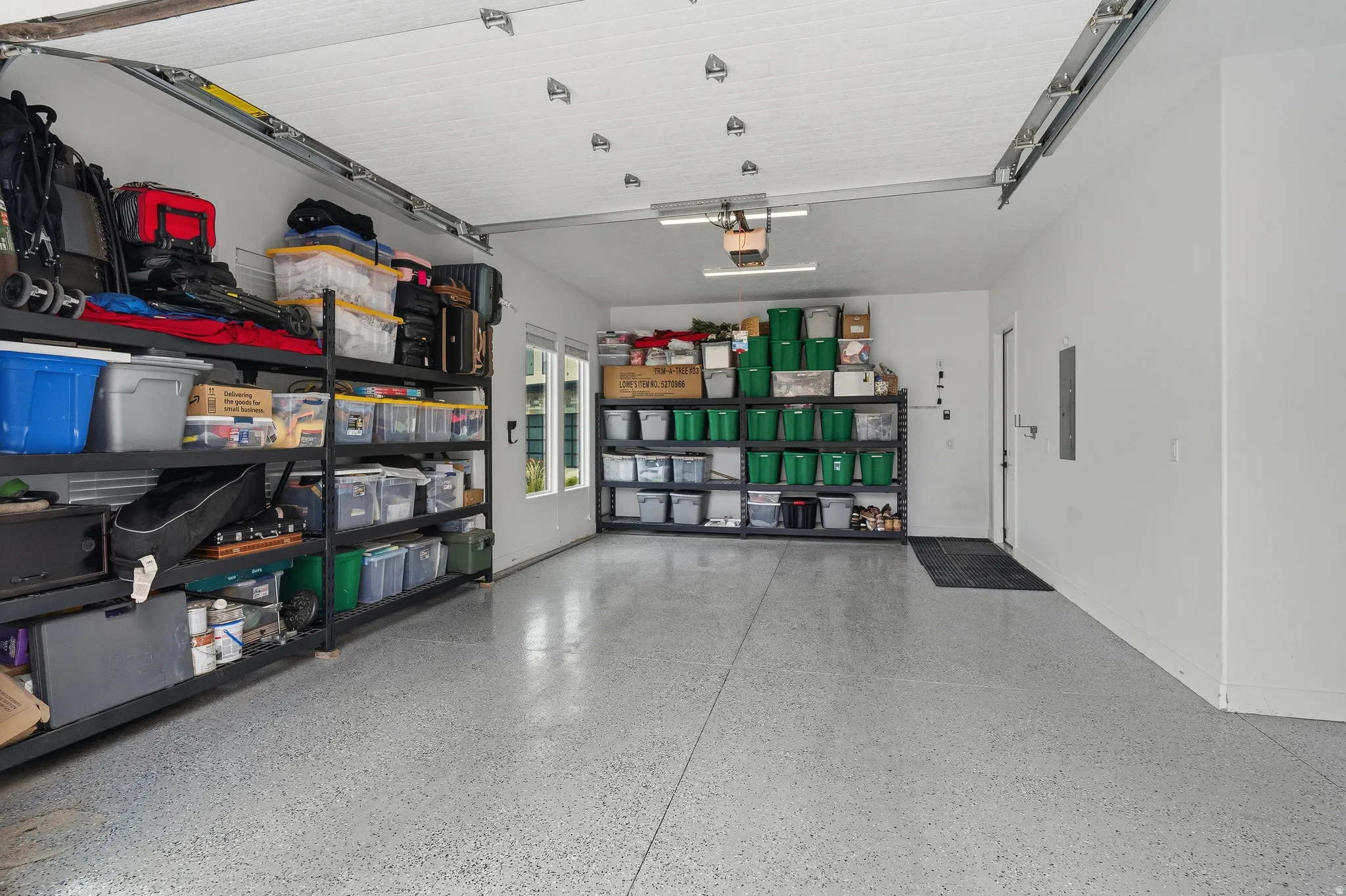 Spacious garage with light gray speckled epoxy flooring.