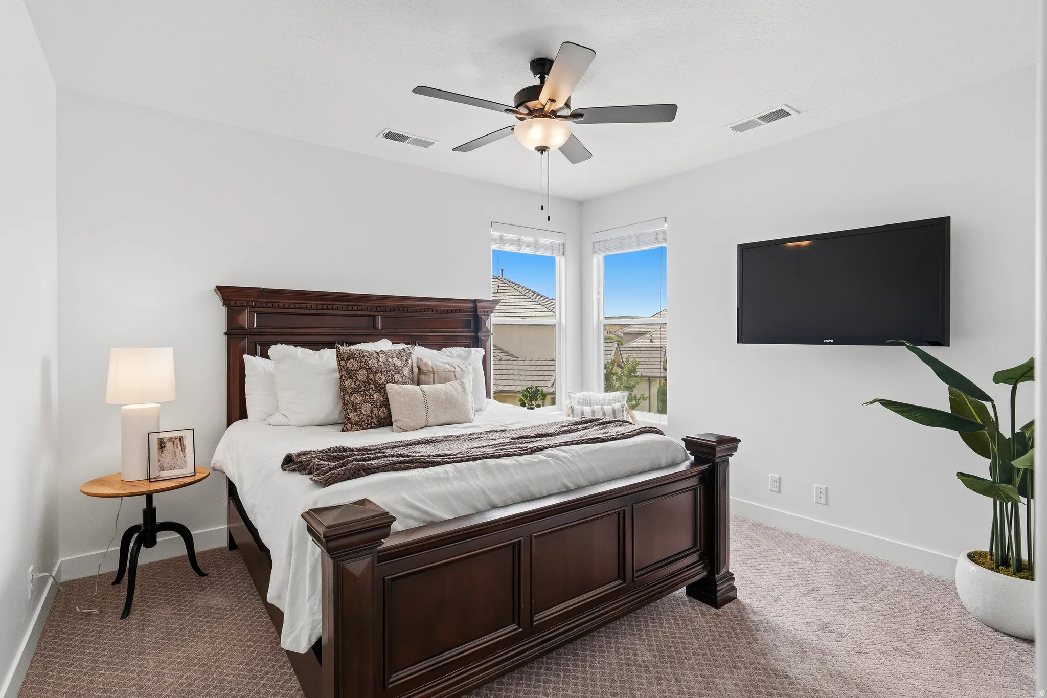 Spacious room featuring neutral carpeting, a ceiling fan with integrated lighting, recessed lighting, and white baseboards.