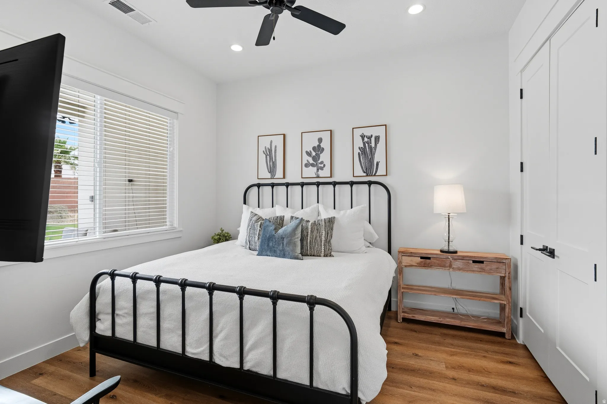 Bright interior space featuring wood-finish flooring, a ceiling fan, recessed lighting, and white trim.