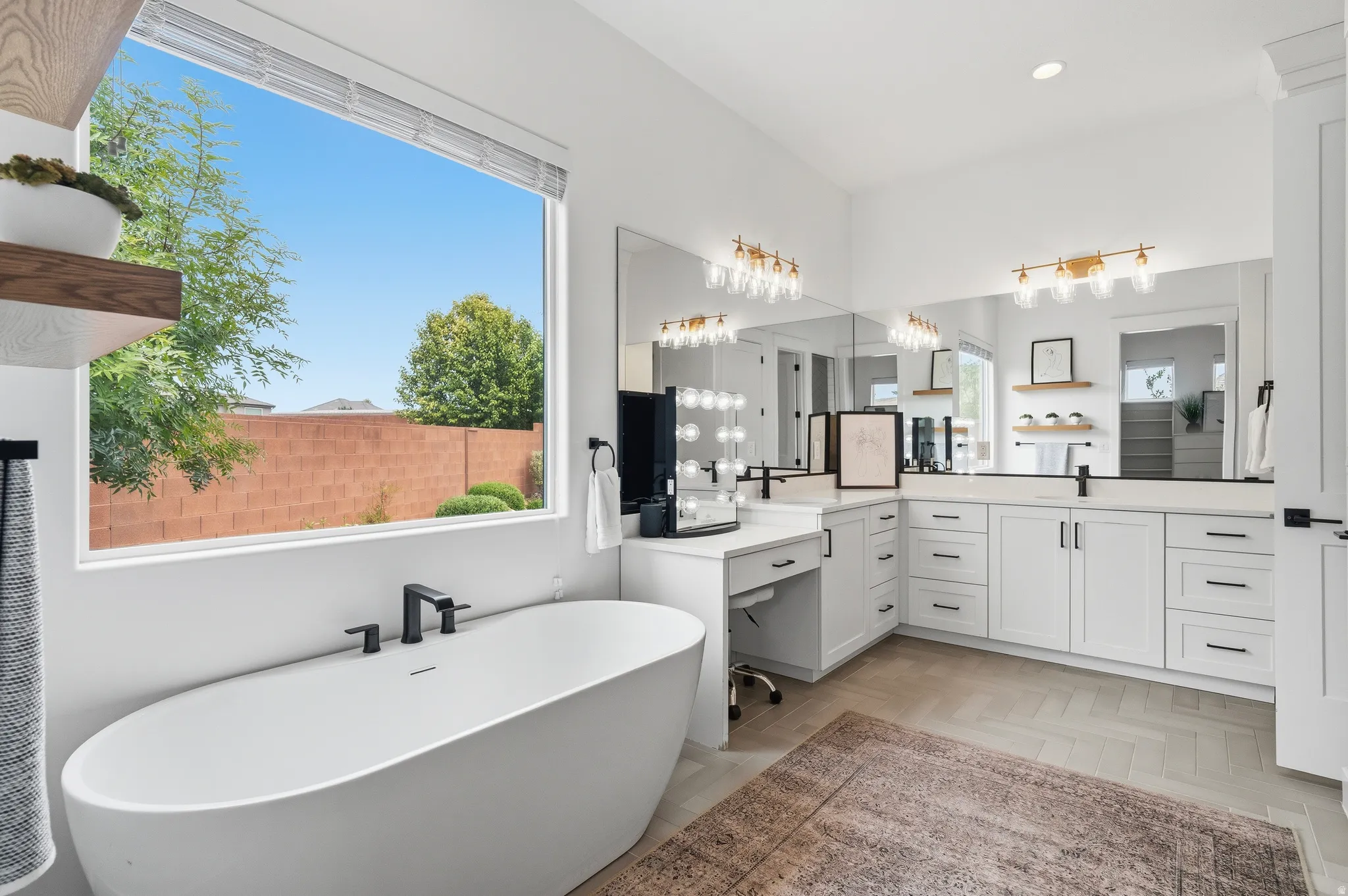 Freestanding soaking tub with matte black fixtures, set against a large window.
