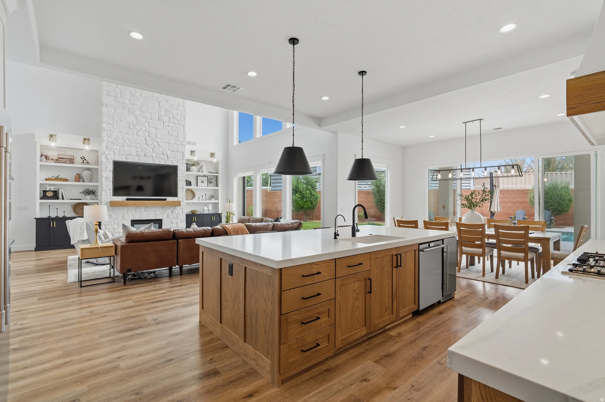Open-concept interior featuring light wood-finish flooring throughout.